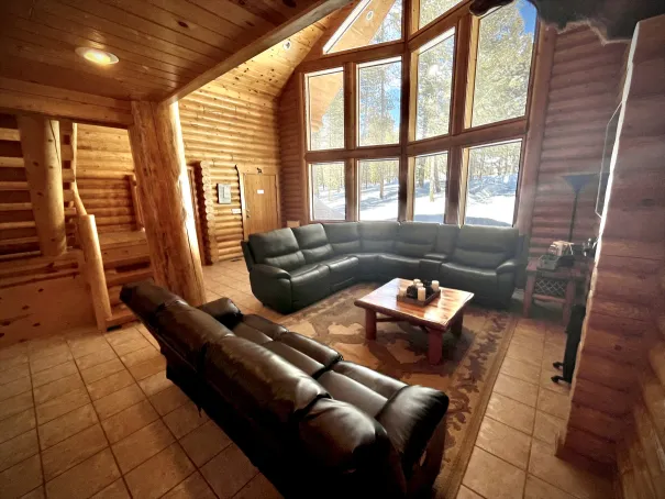 Front of the cabin features a large 2.5-story window with scenic views