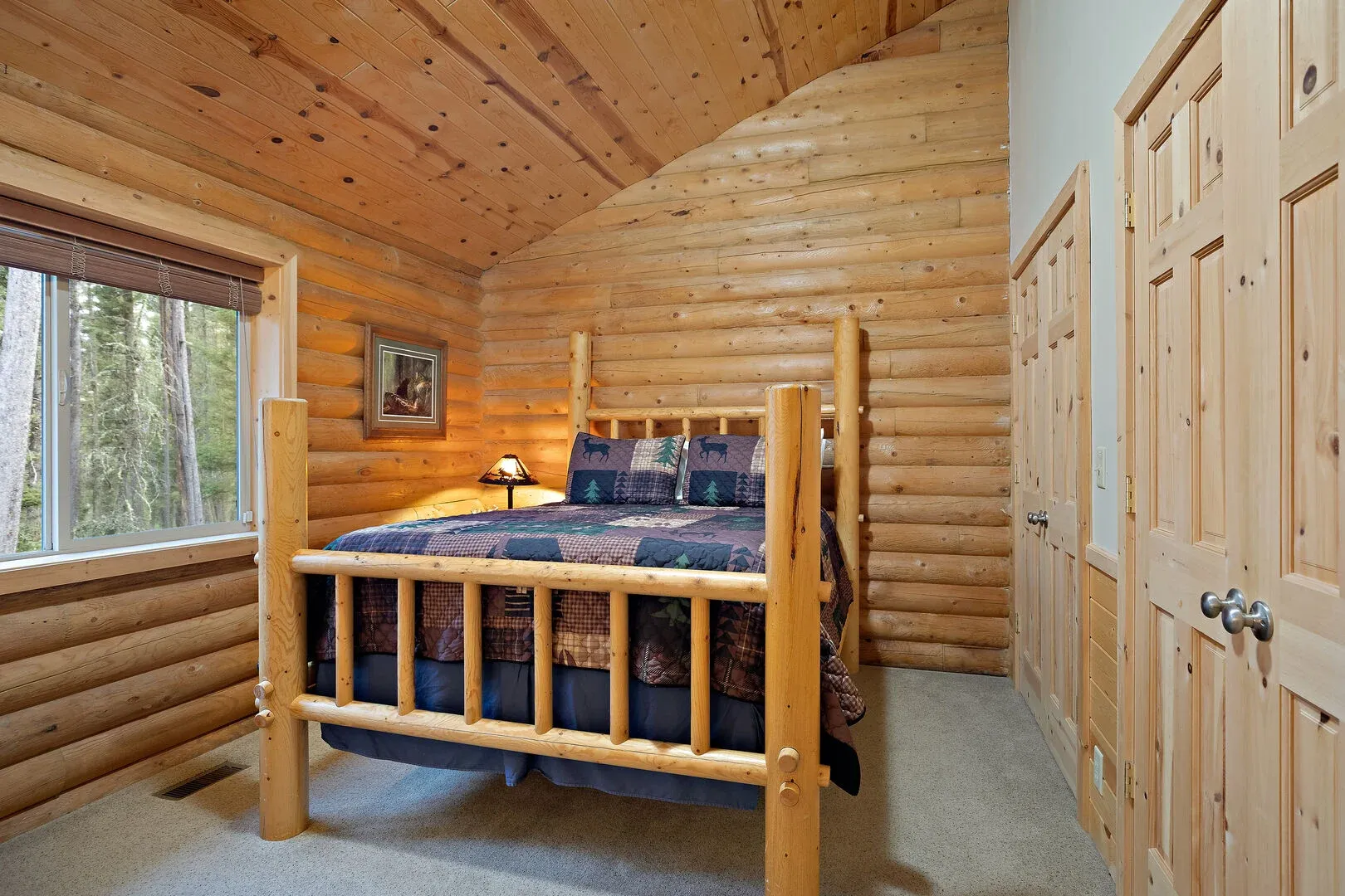 Master bedroom with log bed, mirror, and extra-large closet