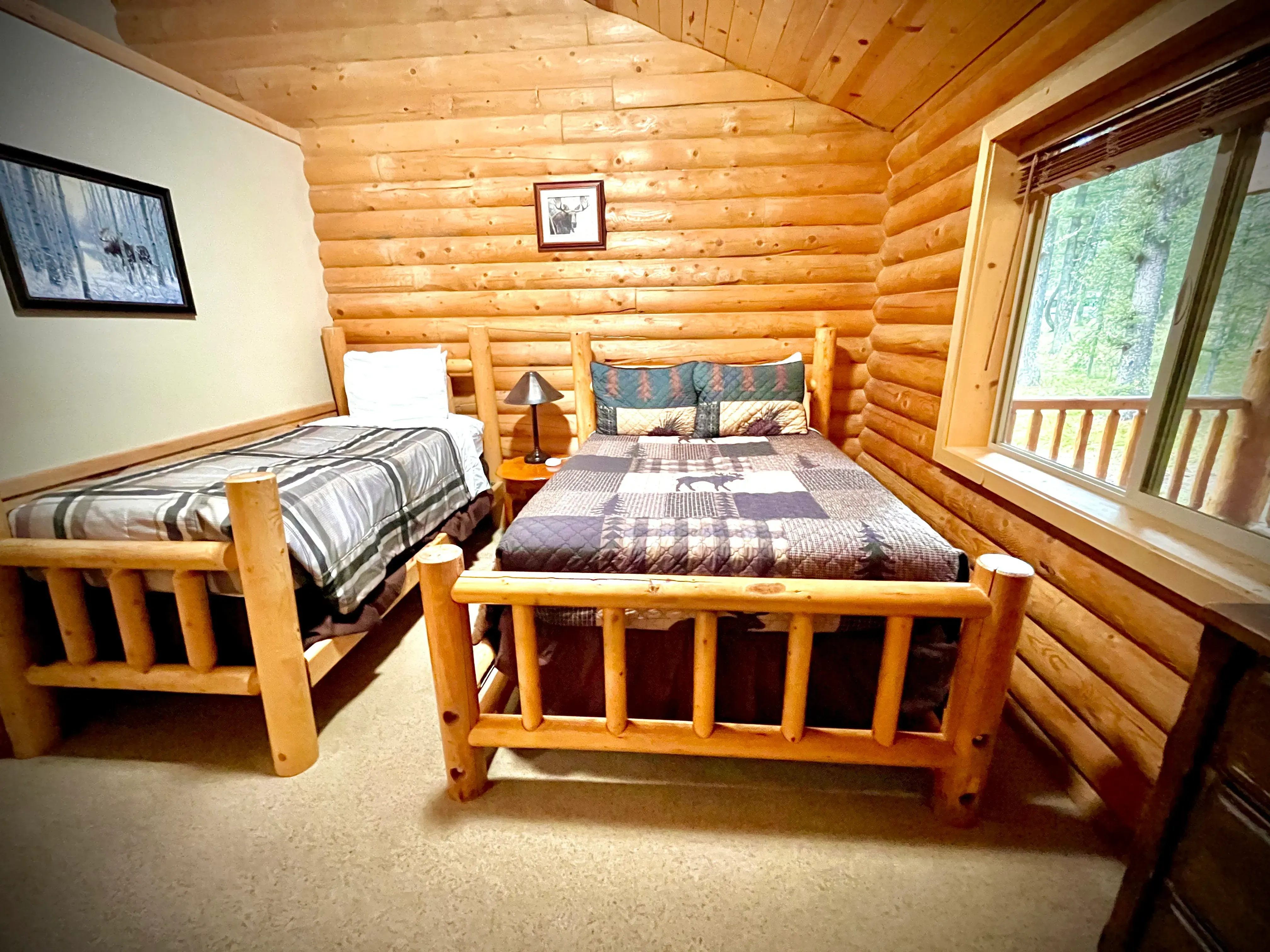 Cozy moose-themed room with twin and double bed