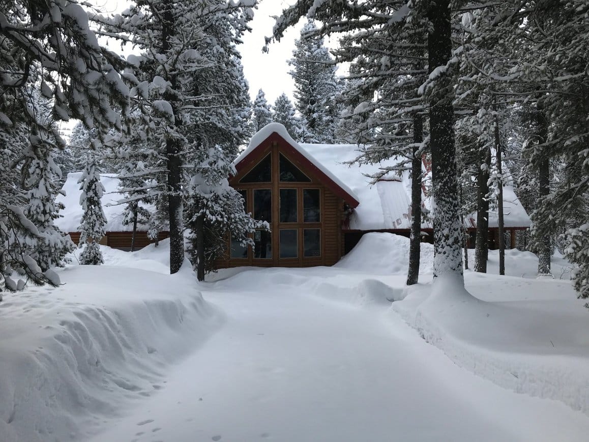 Lodgepole Pines Retreat driveway in winter with deep snow