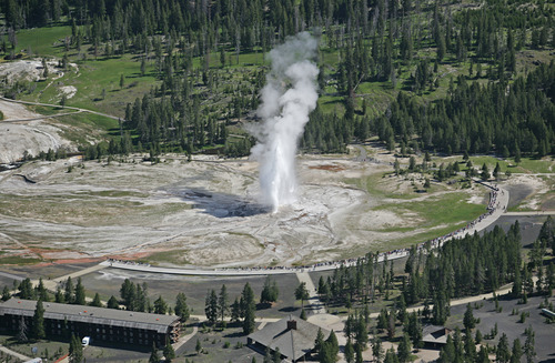Aerial view of Old Faithful boardwalk with visitors watching geysers
