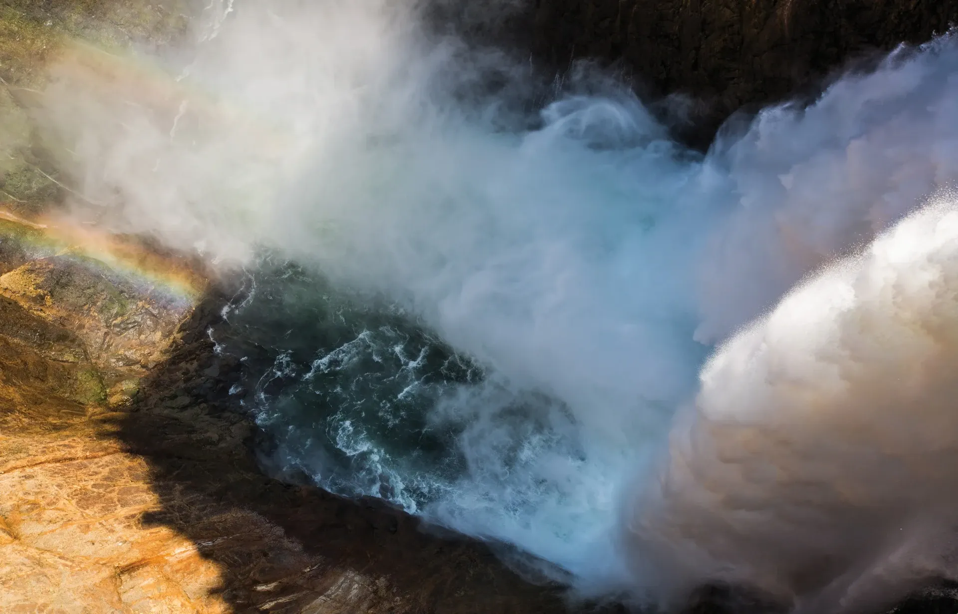 Lower Falls of the Yellowstone with rainbow in the mist from the brink trail