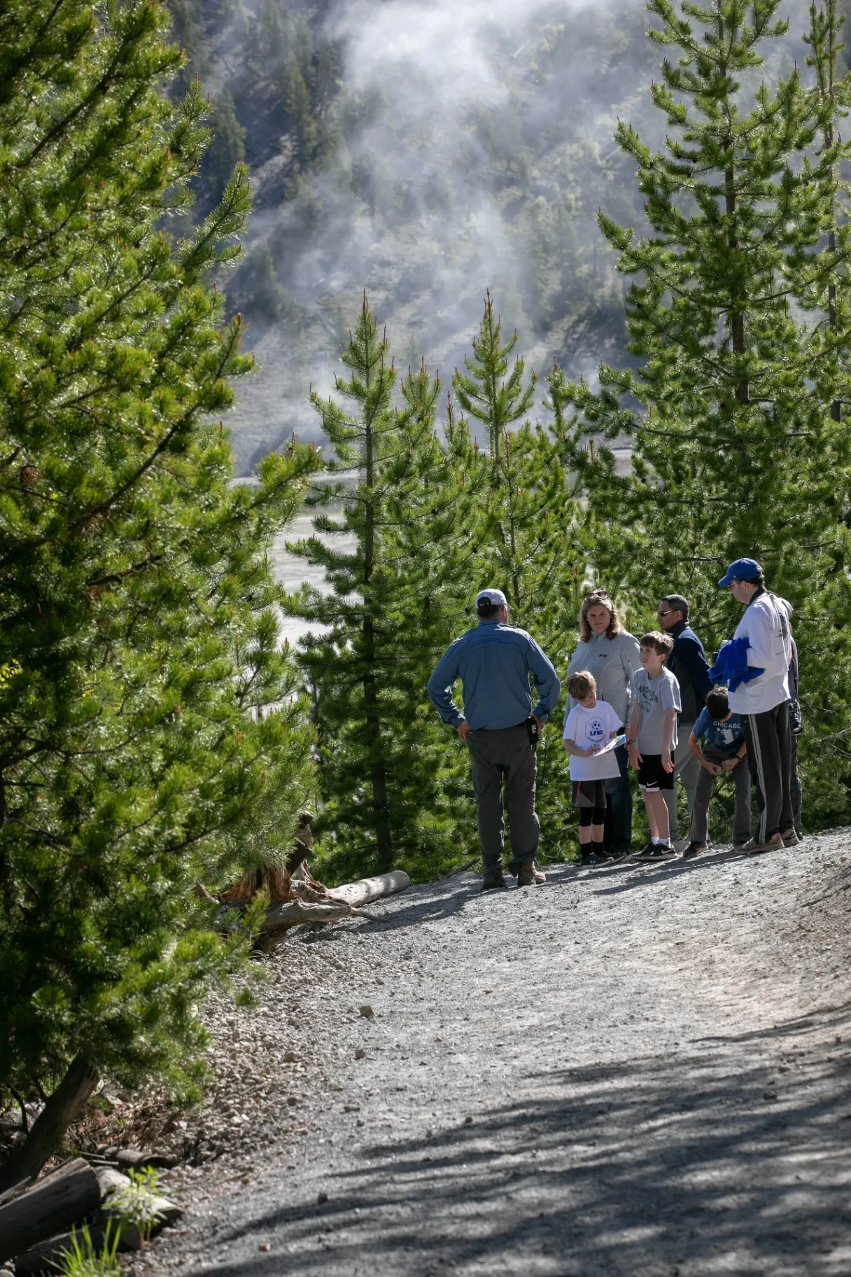 Family walking along boardwalk at Grand Prismatic Spring