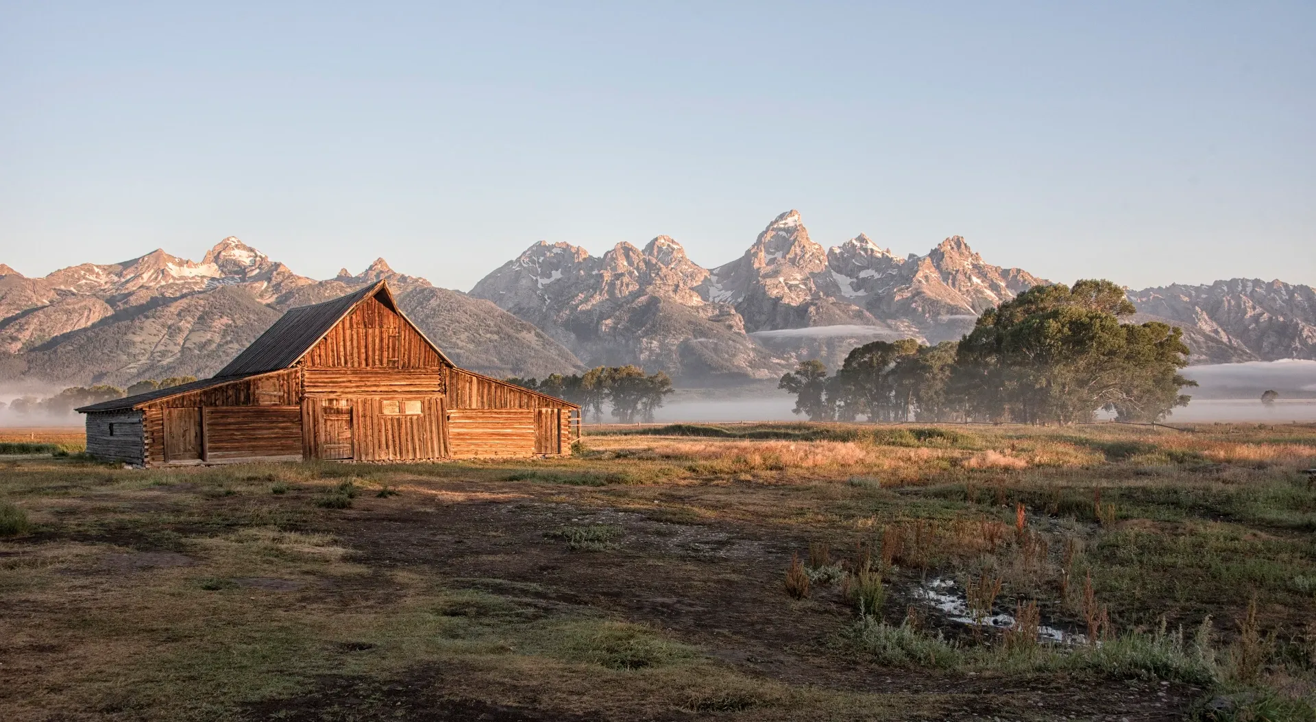 Mormon Row barn with Grand Teton mountains at sunrise